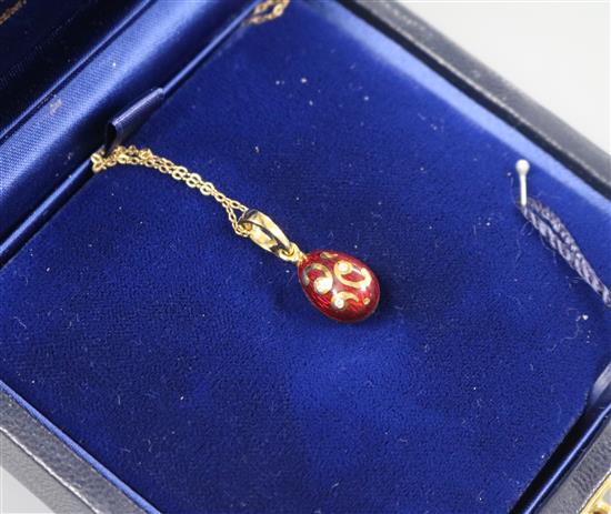 A cased Victor Mayer for Faberge 18ct gold, red enamel and diamond set egg pendant, on 18ct gold chain, numbered 142/500,